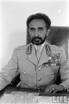 a man in uniform sitting at a desk