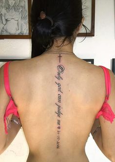 a woman with a cross tattoo on her back