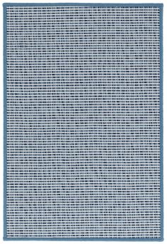 a blue and white rug with small squares on the bottom, in an area that looks like it has been made out of woven fabric