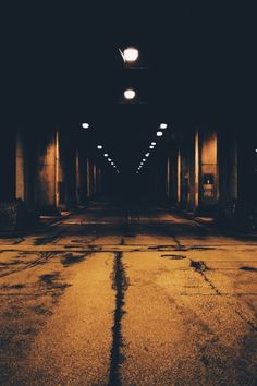 an empty parking lot at night with lights on and no people in the area around it