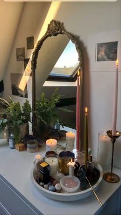 candles are arranged on a tray in front of a mirror