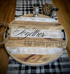 a wooden cutting board with the words together is our favorite place to be on it