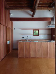 an empty kitchen with wooden cabinets and counter tops