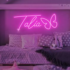 a bed room with a neon sign above it