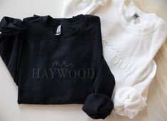 two black and white sweaters with the words mr and mrs hollywood on them are laying next to each other