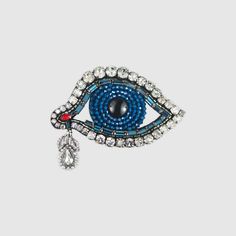 a brooch with an evil eye on it