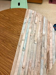 a table made out of wooden planks in a room with other items on the floor