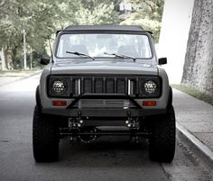 an off - road vehicle is parked on the street