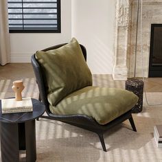 a living room with a chair, coffee table and fireplace