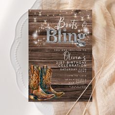 a wooden sign with cowboy boots and sparkles on it is displayed next to a white plate