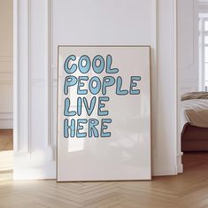 there is a poster that says cool people live here on the wall next to a bed