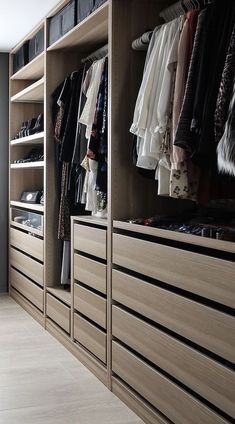 a walk in closet filled with lots of clothes