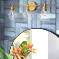 a bathroom mirror sitting next to a wall mounted faucet