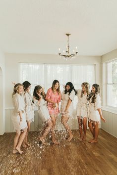 a group of women standing around each other in a room