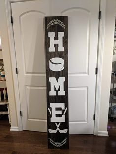 a wooden sign that says home with hockey sticks