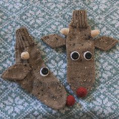 two knitted reindeer mittens with eyes and noses