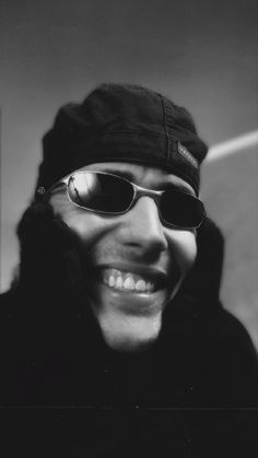 a black and white photo of a person wearing sunglasses