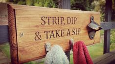 a wooden sign that says strip, dip and take a sip with two stuffed animals hanging on it