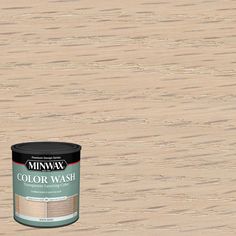 a can of minwax color wash sitting on top of a wooden floor next to a bottle of paint