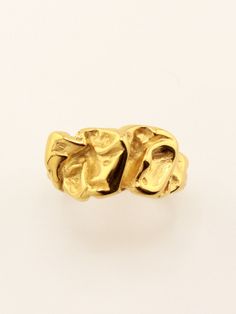 a gold ring that has been made to look like two hands