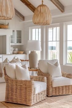 two wicker chairs sitting next to each other in a living room