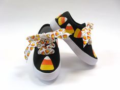 Our  candy corn shoes are real show stoppers. We hand painted sweet candies in yellow, orange and white around our black sneakers.  We added colorful ribbons  for the laces to make the design pop. Perfect for Halloween costumes or parties. These are canvas shoes with hard rubber soles.  Ribbons may vary. PLEASE use our size chart below when selecting your size.  Some think they tend to RUN SMALL and that they are not sized like name brands. They may not wear the same size in our brand as other b Watermelon Shoes, Canvas Shoes Diy, Decorate Shoes, Candy Corn Halloween, Black Tennis Shoes, Halloween Shoes, Halloween Candy Corn, Baby Painting, Diy Toddler