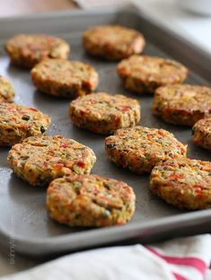 several crab cakes on a baking sheet ready to be baked in the oven or used as an appetizer