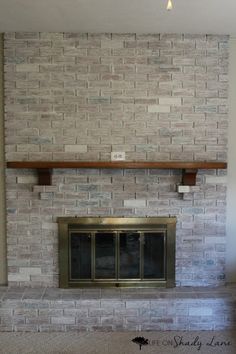 an empty living room with a brick fireplace