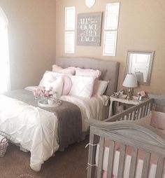 a baby's room with pink and gray decor