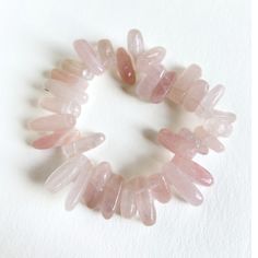 Get ready to rock those good vibes with this handmade stretchy bracelet! Made with the powerful healing properties of rose quartz sticks and durable jeweler's stretch cord, this unique bracelet is an easy way to elevate your style and boost your energy. Perfect for everyday wear or a night out, it's a must-have addition to your crystal collection. (Bonus: It's also a great conversation starter, talk about a win-win!) Handmade in Lincoln, Nebraska Hand-strung Spiritual Rose Quartz Stretch Bracelet, Spiritual Hand-strung Rose Quartz Stretch Bracelet, Pink Rose Quartz Stretch Bracelet With Natural Stones, Pink Rose Quartz Natural Stone Stretch Bracelet, Lincoln Nebraska, Boost Your Energy, Unique Bracelets, Stretchy Bracelets, Great Conversation Starters