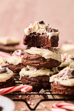 chocolate cookies stacked on top of each other with white frosting and candy canes