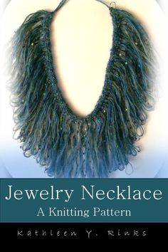 the cover of jewelry necklace, featuring blue and green yarn with fringes on it