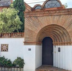 an entrance to a building with arched doorways and brickwork on the outside wall