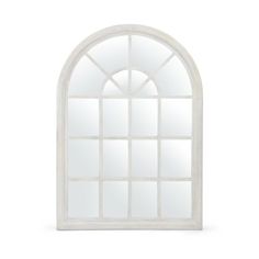 an arched window with white paint and glass panes on the outside, against a white background