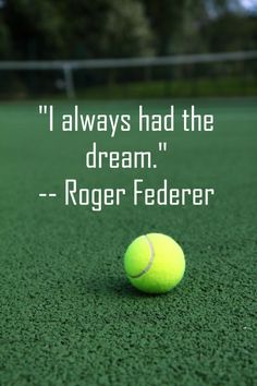 a tennis ball sitting on top of a green court