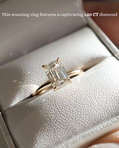 a woman's hand holding an engagement ring in a white box with the words, this stunning ring features a captivating leo