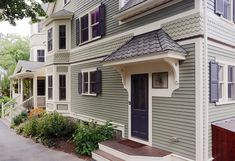 the house is painted gray and has black shutters