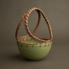 two woven baskets sitting next to each other on top of a gray surface with no one in it