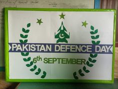 a sign that says pakistan defence day on the side of a wall in a classroom