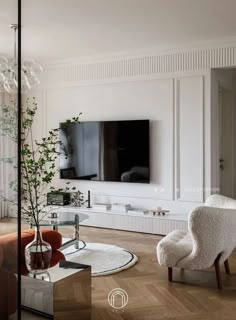 a living room filled with furniture and a flat screen tv mounted on the wall above a fireplace