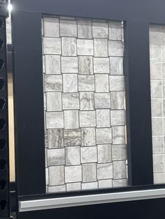 a black stove top oven sitting inside of a kitchen next to a wall with white tiles on it