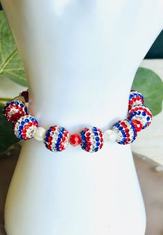 The adorable red, white, and blue rhinestone beaded Fourth of July stretch bracelet. Made in the USA. This bracelet is the perfect accessory for any womens wardrobe. Stack it with another piece or wear on its own.   This bracelet is a great womens gift.  The bracelet is an approximate length of 7" Try to roll your bracelet on instead of stretching it. It should last longer that way. Adjustable White Beaded Bracelets With Rhinestones, Red Crystal Beaded Bracelets, Adjustable White Beaded Bracelet With Rhinestones, Adjustable Colorful Beaded Jewelry For 4th Of July, Beaded Bracelet For 4th Of July, Red Jewelry With Colorful Beads For 4th Of July, Patriotic Beaded Jewelry, Red Beaded Bracelets For 4th Of July, Red Beaded Jewelry For 4th Of July