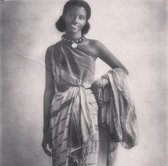 an old photo of a woman wearing a dress