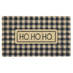 a black and white door mat with the word ho ho on it, in front of a