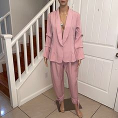 The Gorgeous Blush Pink Blazer Pant Suit Is Perfect For Work Or Evening Wear. The Suit Is Made Of 95% Polyester & 5% Spandex. The Material Has A Slight Stretch. Single Button Front Closure On The Blazer. Sleeves Are Gathered To Give A More Stylish Appeal. Pants Have A Hook & Eye Closure With A Front Zipper. The Pants Have A Tie At The Ankles. The Suit Has No Pockets. Fitted Pant Set With Pockets For Spring, Chic Office Pant Set For Spring, Pink Long Sleeve Pant Set For Work, Fitted Pant Set For Workwear In Spring, Fitted Pant Set For Spring Workwear, Chic Spring Workwear Pant Set, Fitted Pant Set For Office In Spring, Spring Tailored Long Sleeve Pantsuit, Spring Solid Color Long Sleeve Pantsuit