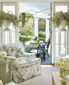 a living room filled with furniture and flowers