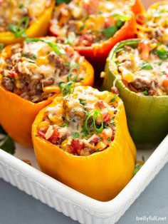 several stuffed peppers in a white bowl