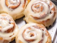 several cinnamon rolls sitting on top of a pan