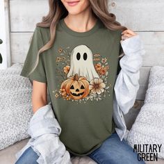 Ghost Halloween Shirt for Halloween Pumpkin Tee Retro Ghost Floral Tee Funny Halloween T-Shirt Spooky Season Holiday Apparel Ghost Tshirt If you are looking for soft, well designed, and comfy t -shirts, you have come to the right place! We strive to provide beautiful shirts for all occasions as well as a great customer experience. If you have any questions about our shirts, please feel free to shoot us a message anytime. We try our best to message everyone back within 24 hours. Product Details U Spooky Pre-shrunk T-shirt For Fall, Spooky Fall T-shirt Pre-shrunk, Green Halloween T-shirt With Character Print, Ghost Tshirt, Retro Ghost, Holiday Apparel, Floral Tee, Ghost Halloween, Halloween T Shirt