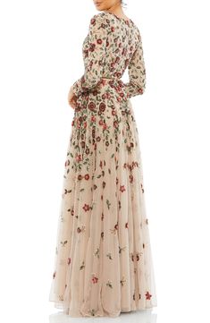 A garden of sequined flowers catches the light and shimmers through the evening on a graceful floor-length gown framed with mesh sleeves and a full skirt. 60 1/2" length (size 8) Jewel neck Long sleeves Partially lined 100% polyester Spot clean Imported Asian Owned/Founded Beads Embellishment, Long Sleeve Formal Dress, Sleeve Formal Dress, Long Sleeve Evening Gowns, Long Formal Dress, Glamour Style, Embellished Gown, Beautiful Dress Designs, Daytime Dresses